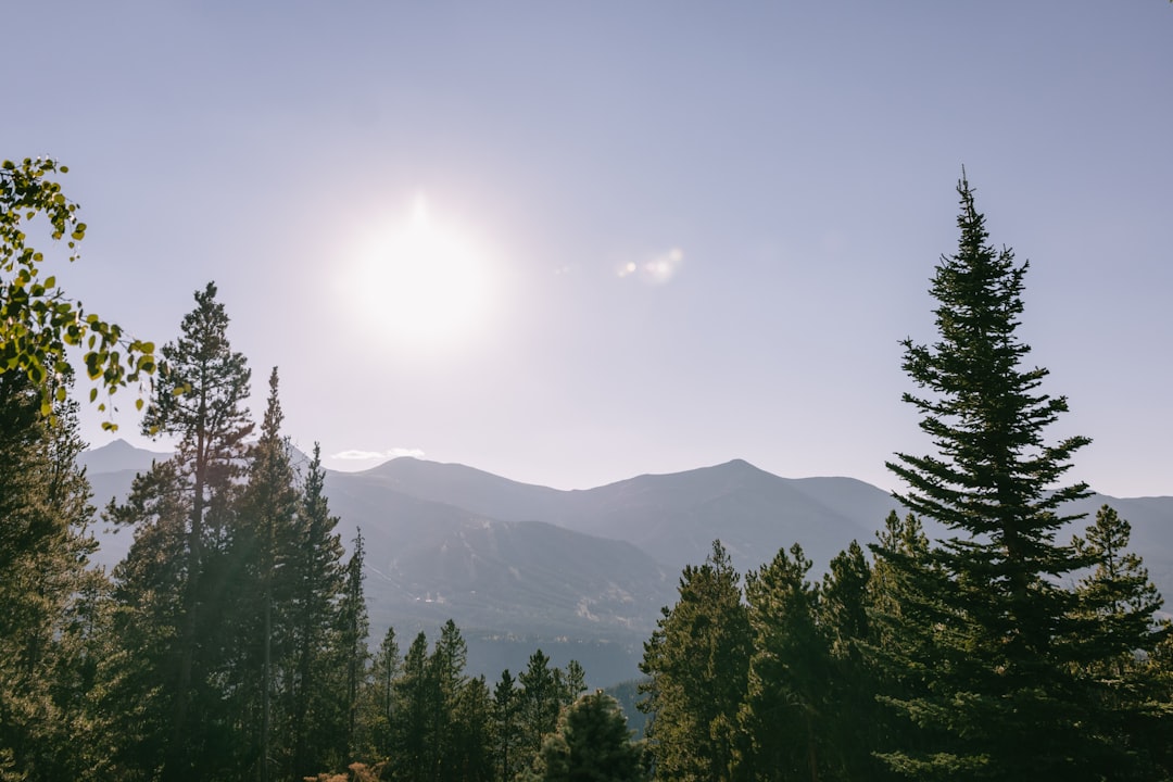 the sun is shining over a mountain range breckenridge colorado golf clubhouse mountain town summer travel