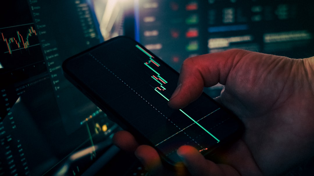 trader analyzing stock market data on smartphone and phone data security finance app lock icon safe money