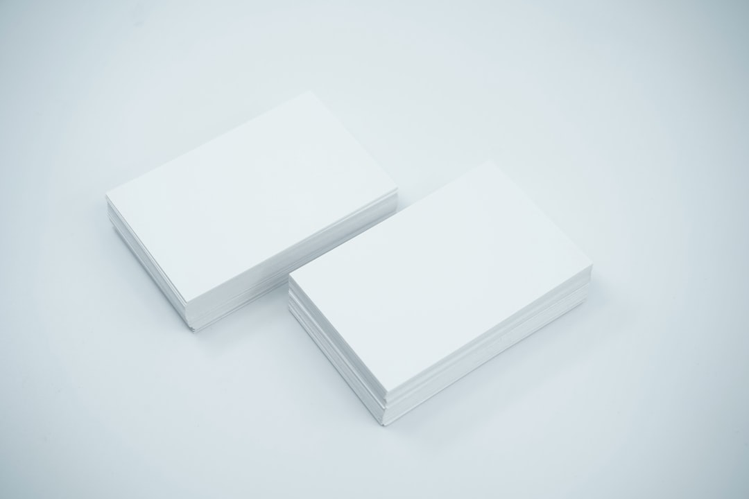 two blank business cards sitting on top of each other printing press business cards paper samples