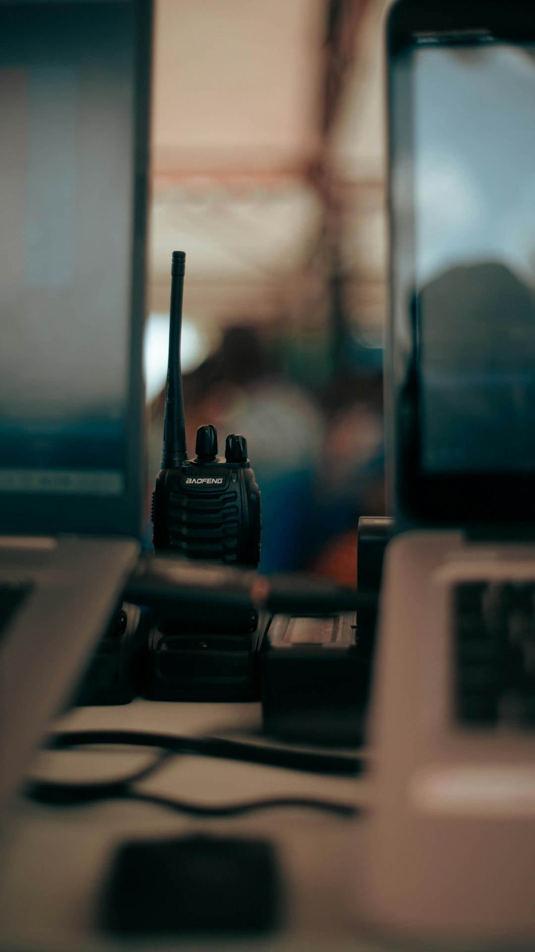 two laptops and a cell phone on a desk emergency radios responders communication gear
