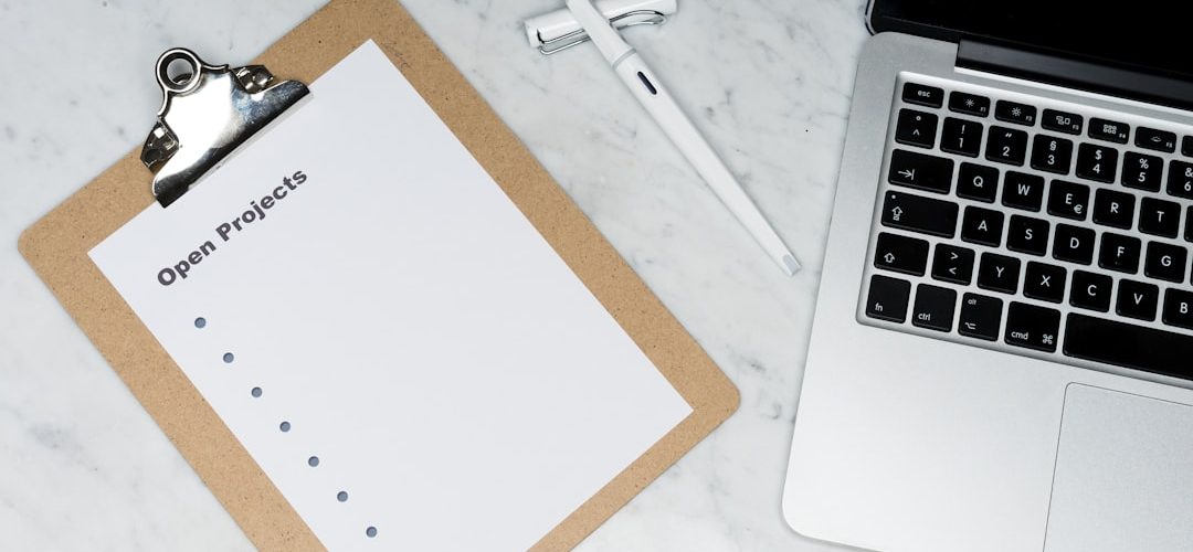 white printer paper beside silver laptop computer msp service checklist email authentication happy clients