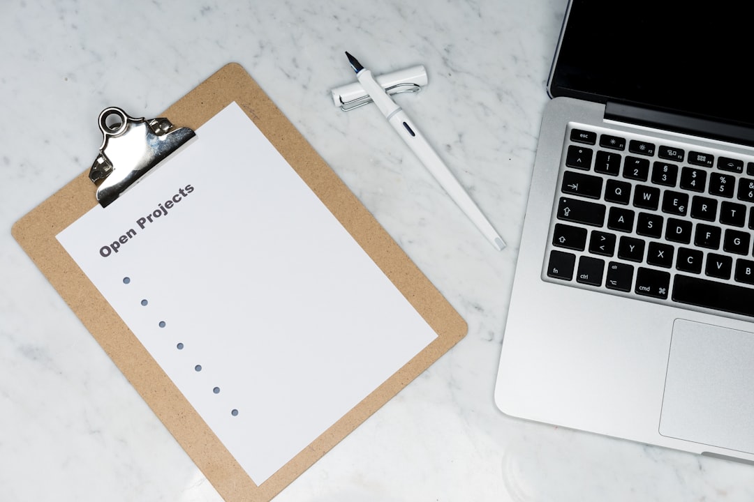white printer paper beside silver laptop computer msp service checklist email authentication happy clients