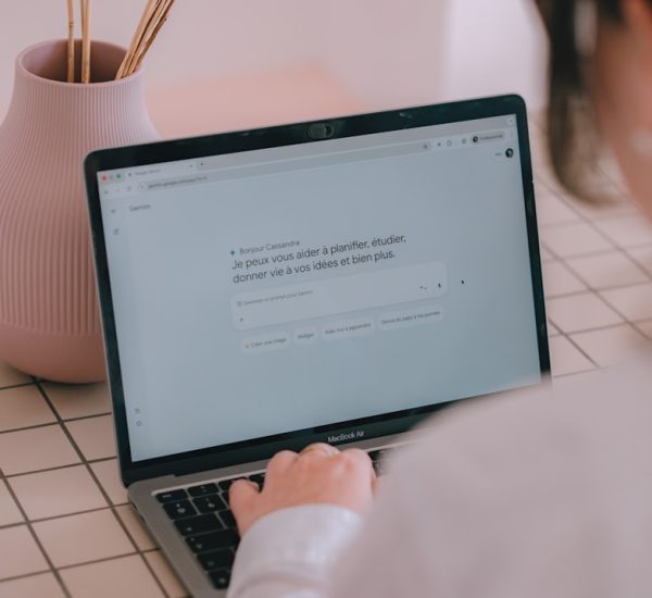 Paper MCP: Paper MCP vs Figma for AI-Assisted Design Workflows 8 woman typing on a laptop with a vase nearby person using ai clear prompts digital assistant