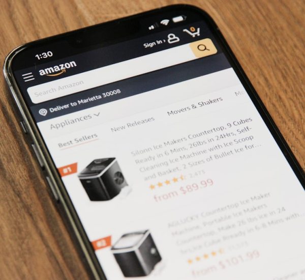 Magento Community vs Enterprise: Complete Feature Comparison for 2026 2 a cell phone sitting on top of a wooden table amazon shopping product search online store visibility