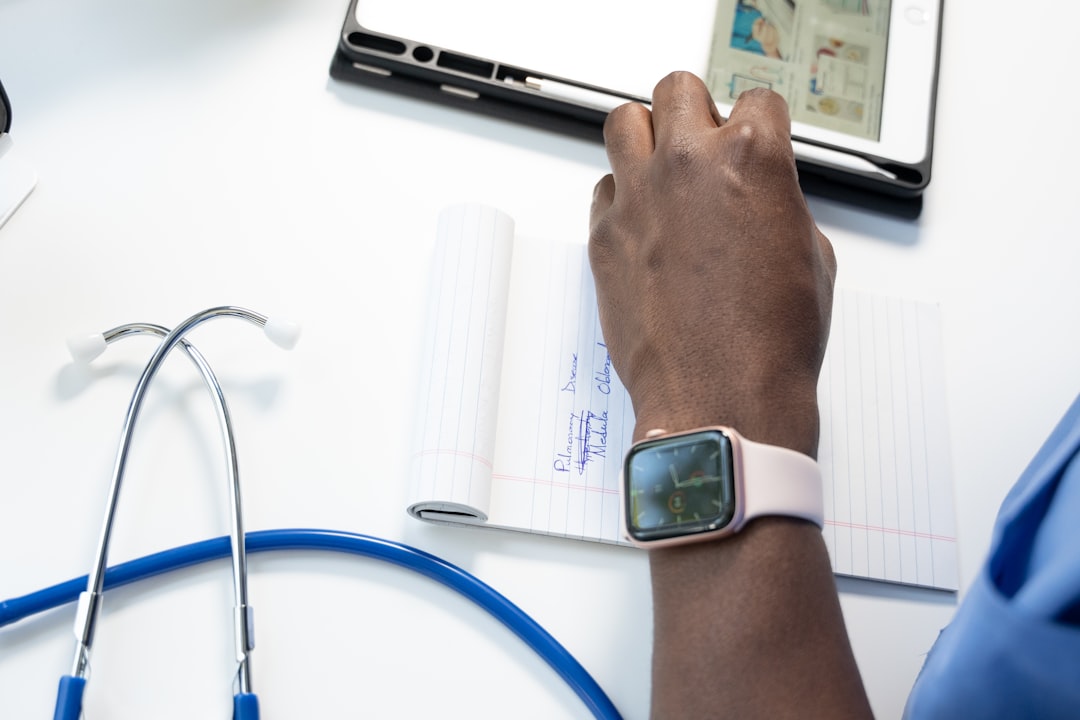 a hand holding a smart watch insurance claims medical coding automated workflow