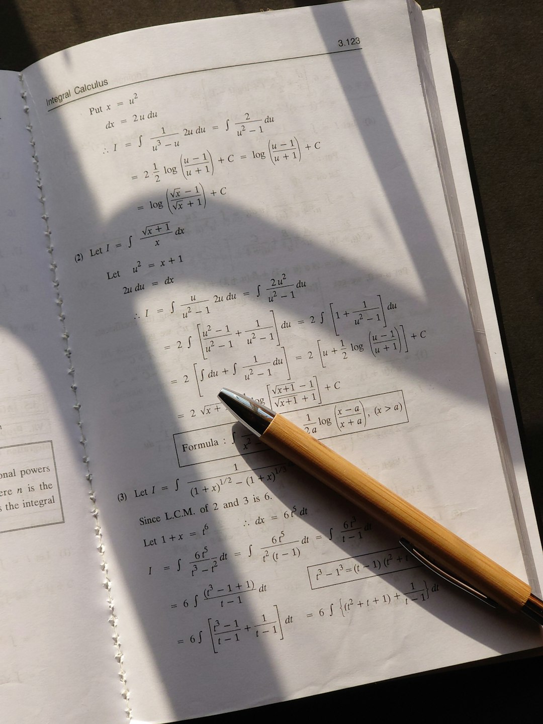 a pen sitting on top of a piece of paper student solving math worksheet answers algebra notebook