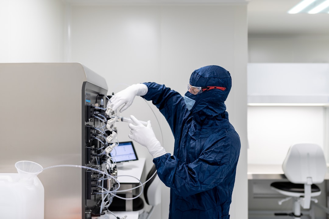 a person in a lab coat working on a computer biotech team assay workflow clinical samples