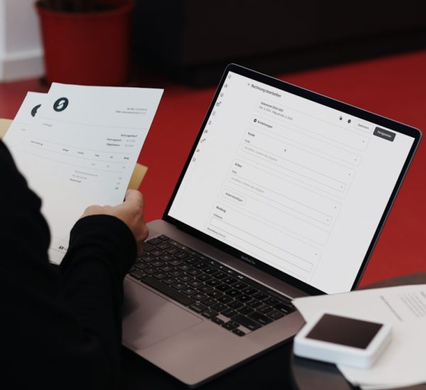 Temporary Identity Certificate vs Digital ID: Which Identity Document Is Better for Online Verification? 6 a person sitting at a desk with a laptop and papers online fax business documents digital office