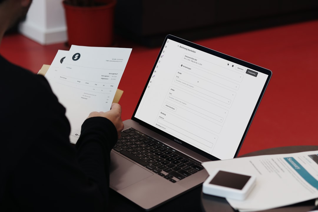 a person sitting at a desk with a laptop and papers online fax business documents digital office