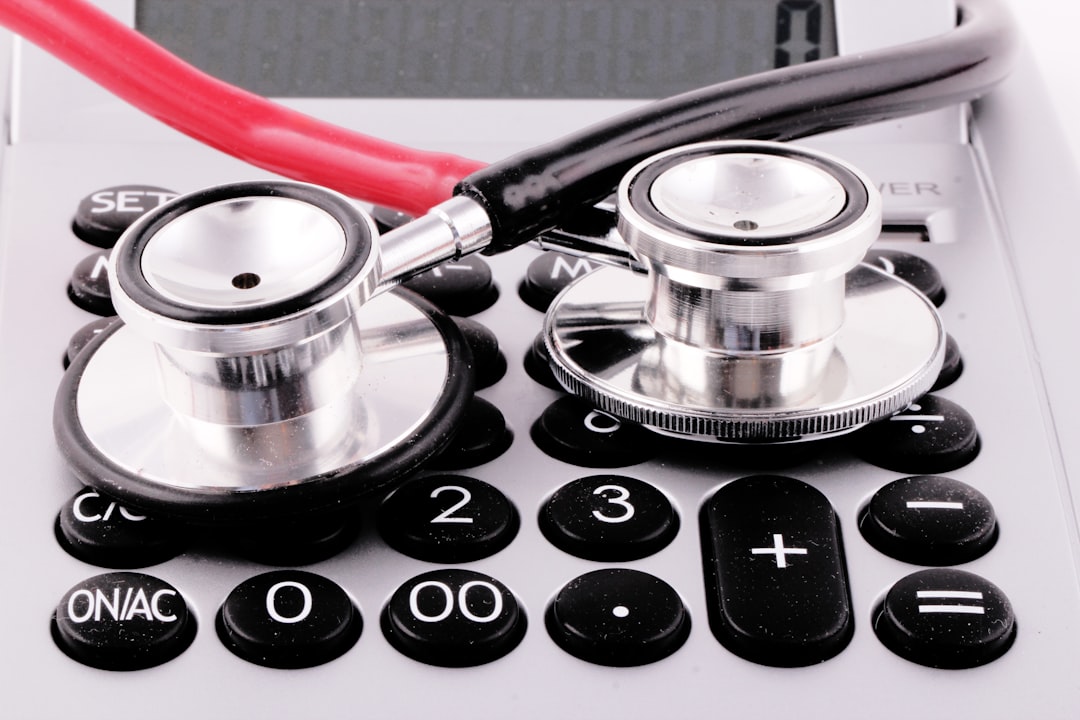 a stethoscope sitting on top of a calculator insurance claims medical coding automated workflow