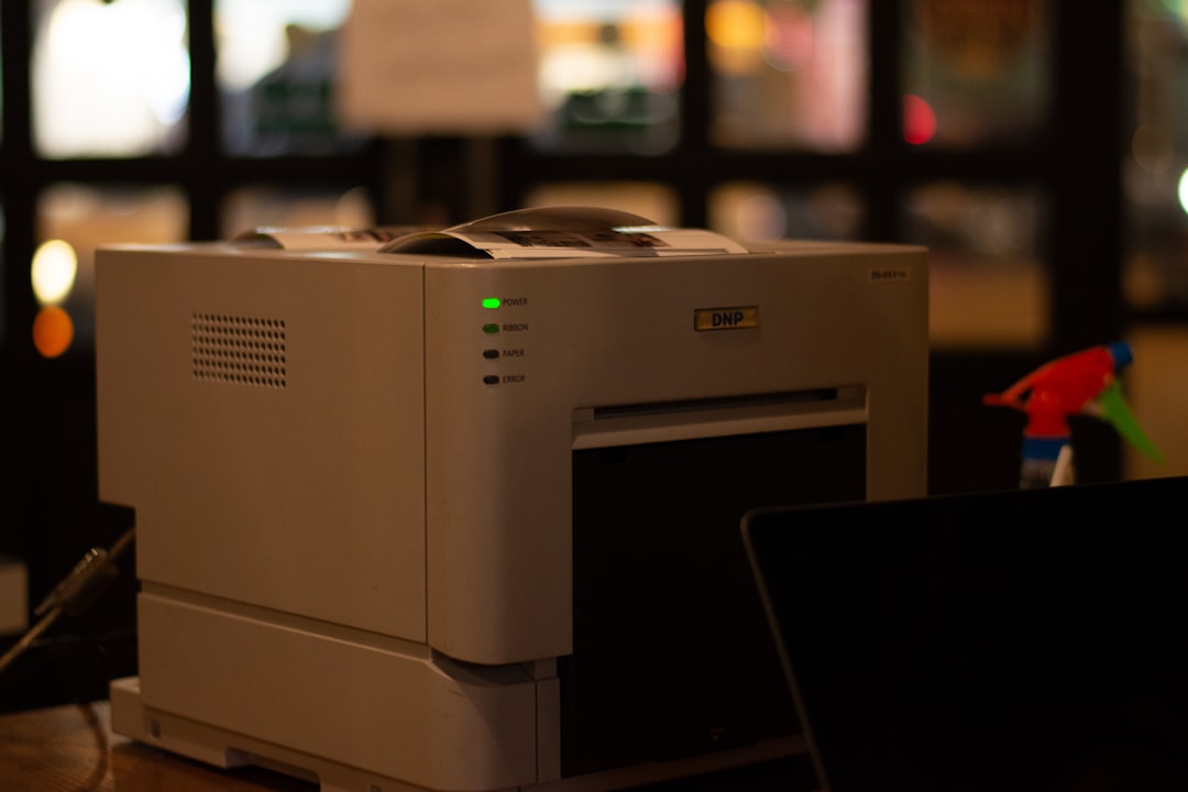 a white printer on a table windows printer settings ip address setup test page