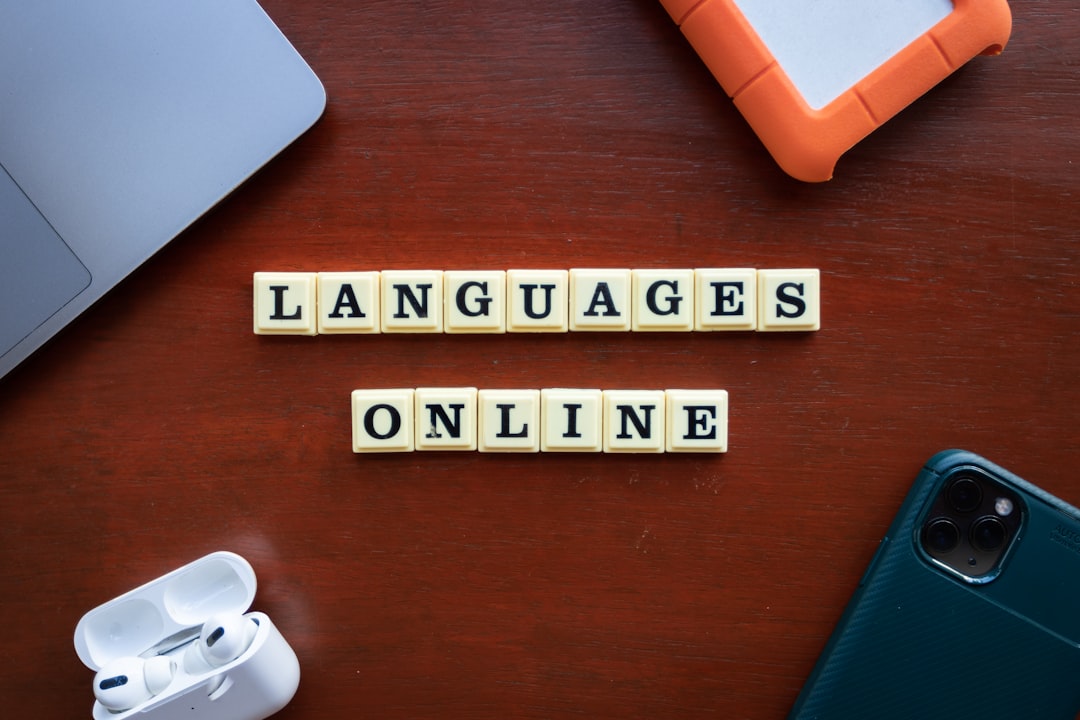 a wooden table topped with scrabble tiles that spell out languages localized content language review international marketing