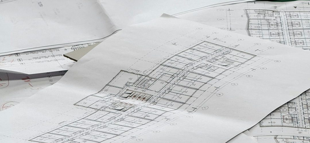 architectural blueprints spread out on a surface construction takeoff floor plan material calculation
