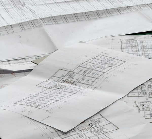 architectural blueprints spread out on a surface construction takeoff floor plan material calculation