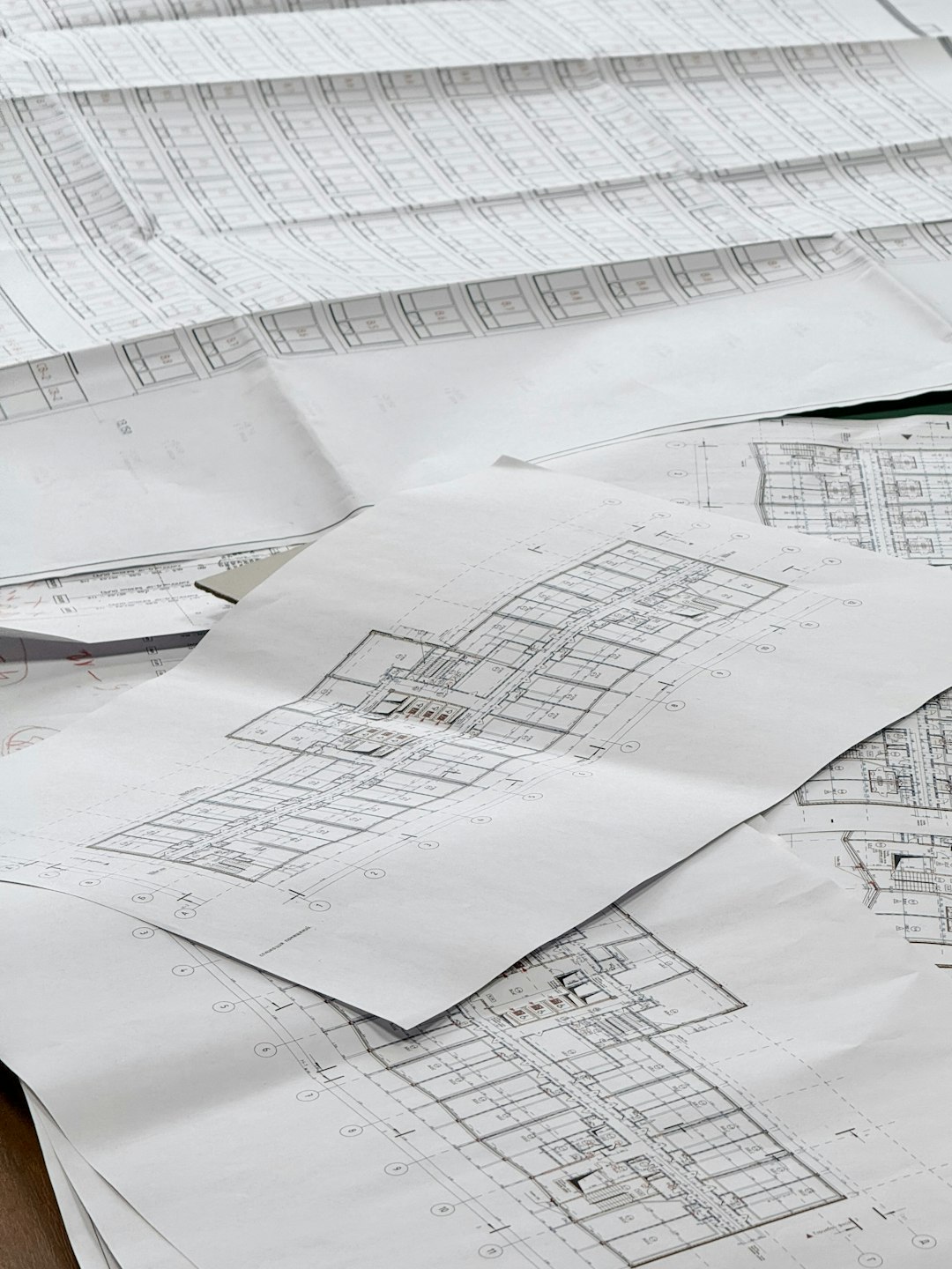 architectural blueprints spread out on a surface construction takeoff floor plan material calculation