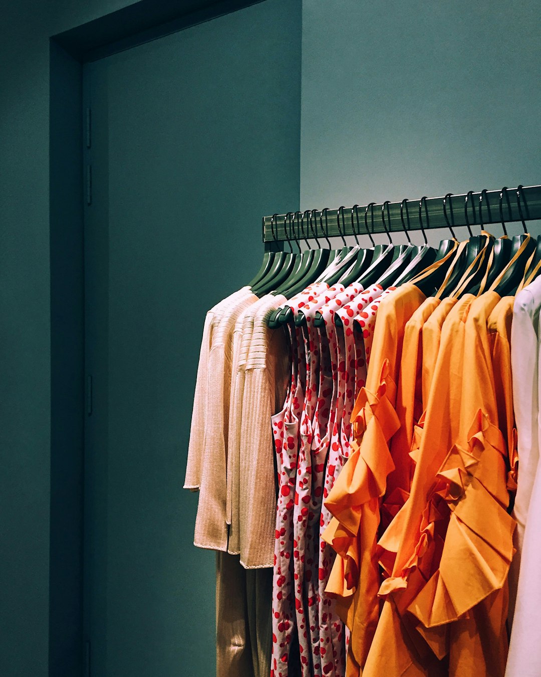 assorted color shirt lot hang on rack personal shopper wardrobe consultation client fitting boutique