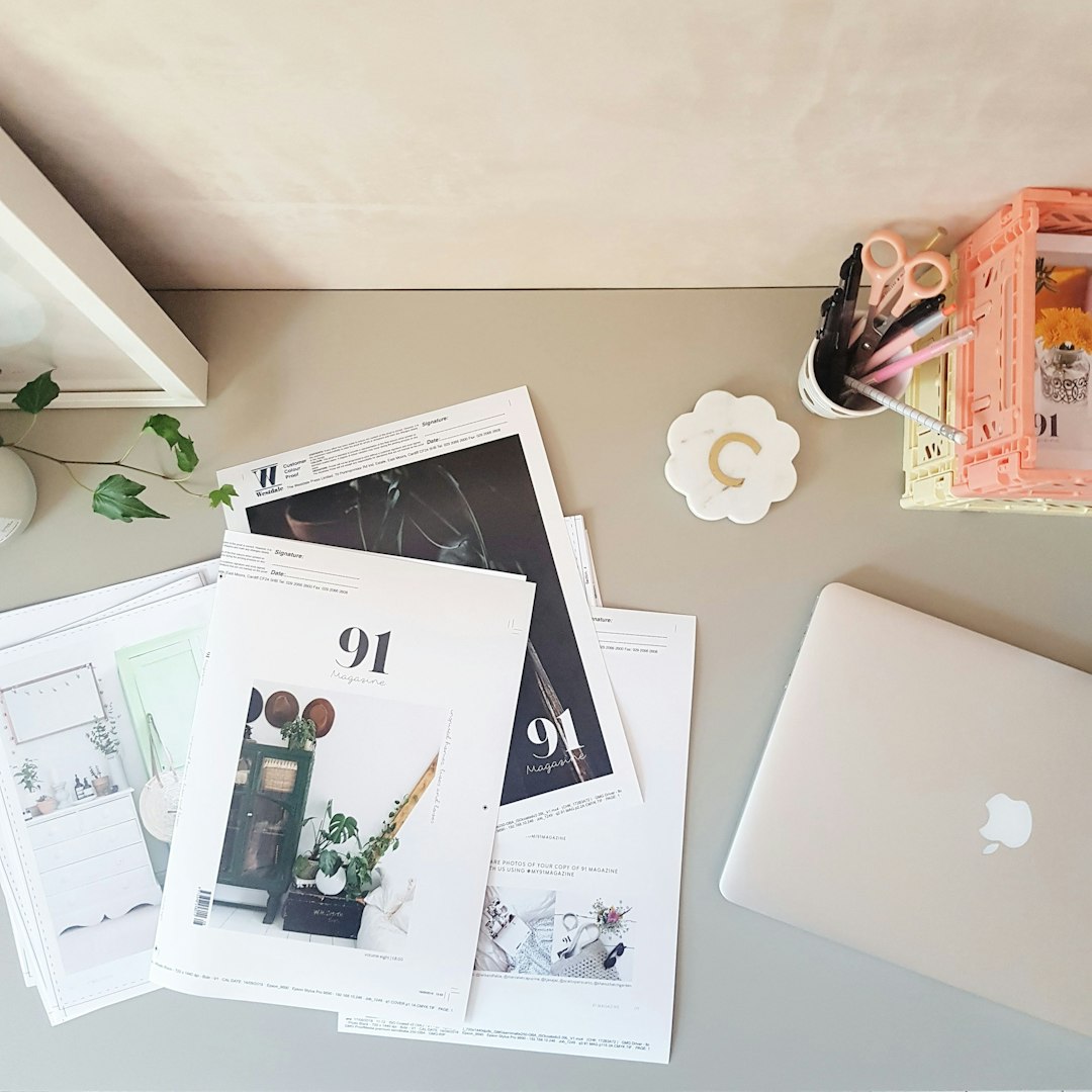 books near apple macbook near wall fashion portfolio mood board styled outfits creative desk