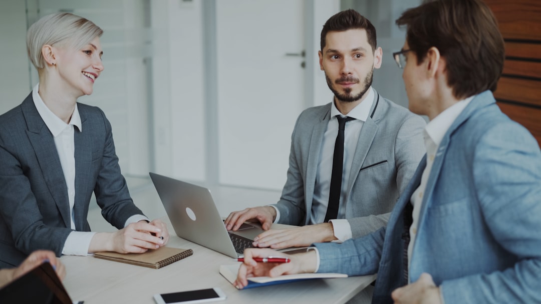 business professionals in a meeting around a table negotiation quote sales representative business buyer
