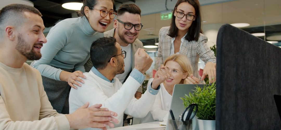 diverse team celebrating success at office desk customer support team dashboard smiling 1