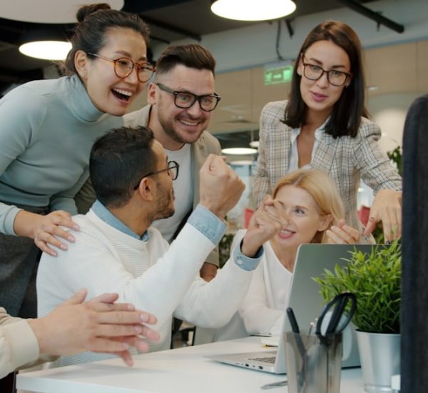 diverse team celebrating success at office desk customer support team dashboard smiling 1