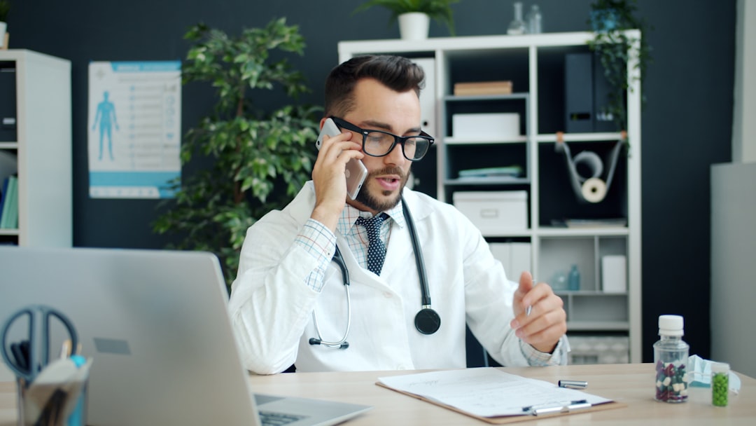 doctor talking on the phone in his office doctor office patient payments billing software