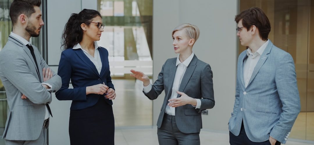four business professionals in a meeting discussing ideas sales team customer discussion business value