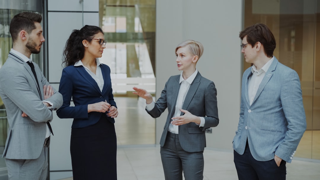 four business professionals in a meeting discussing ideas sales team customer discussion business value