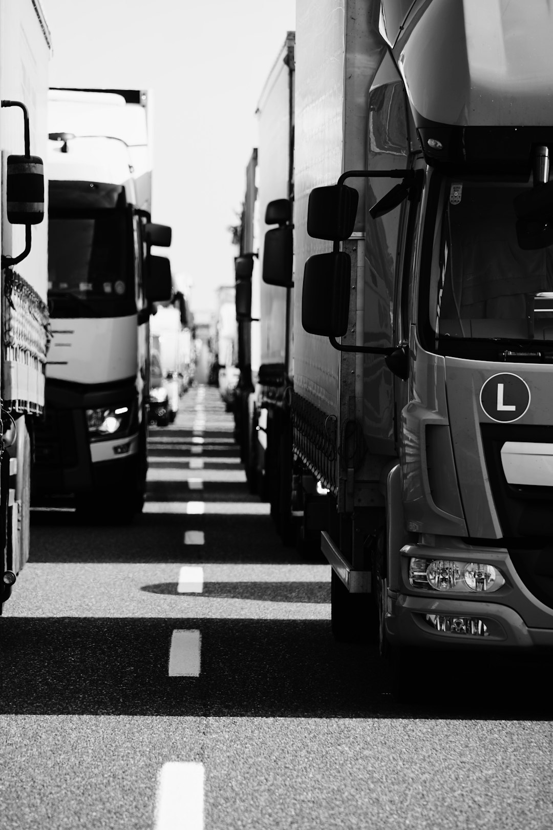 grayscale photo of cars on road freight forwarding delivery trucks digital workflow