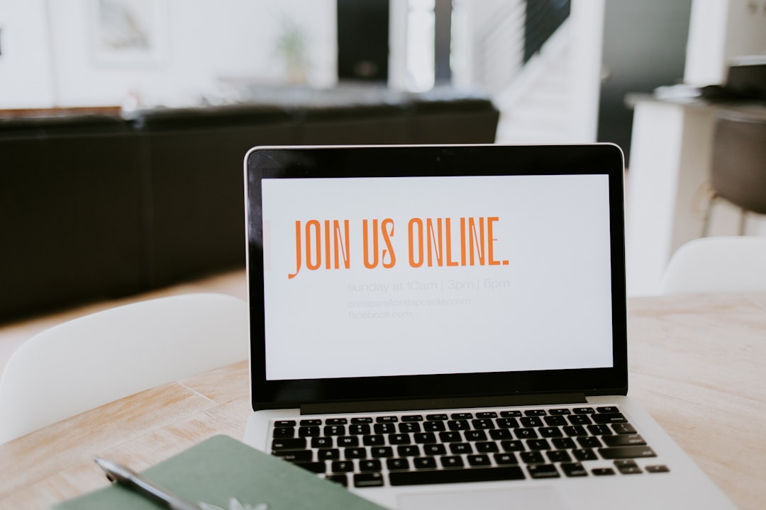 macbook pro on brown wooden table webinar registration online presentation laptop audience