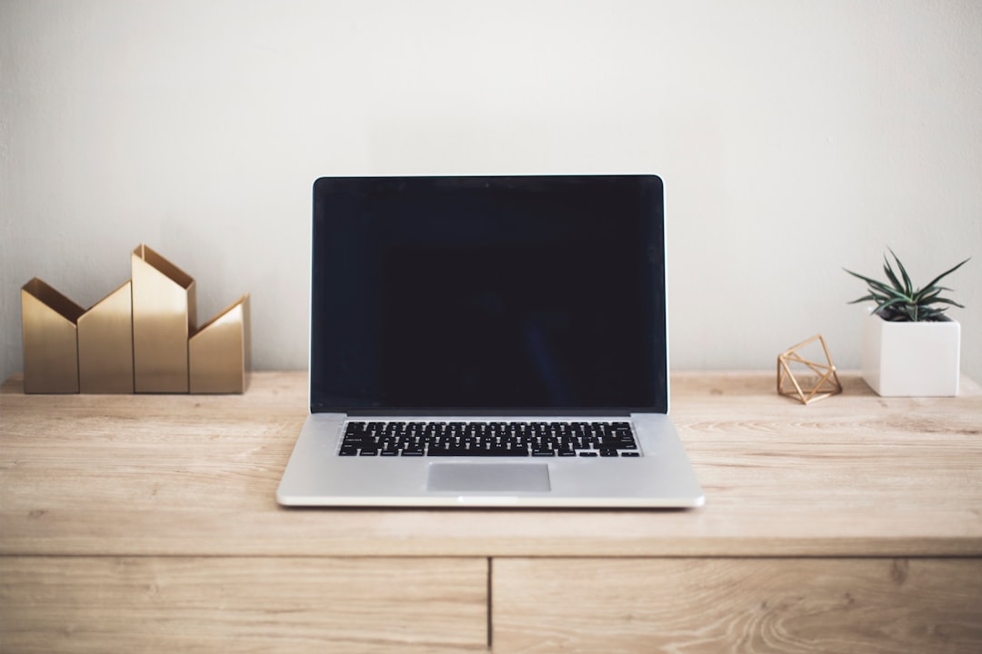 macbook pro on top of brown table professional email price inquiry office laptop