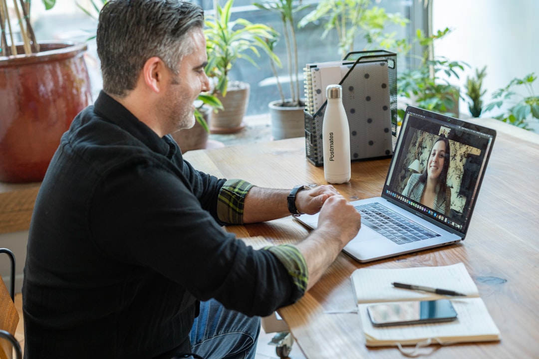 man in black sweater using macbook pro digital workplace team collaboration online meeting