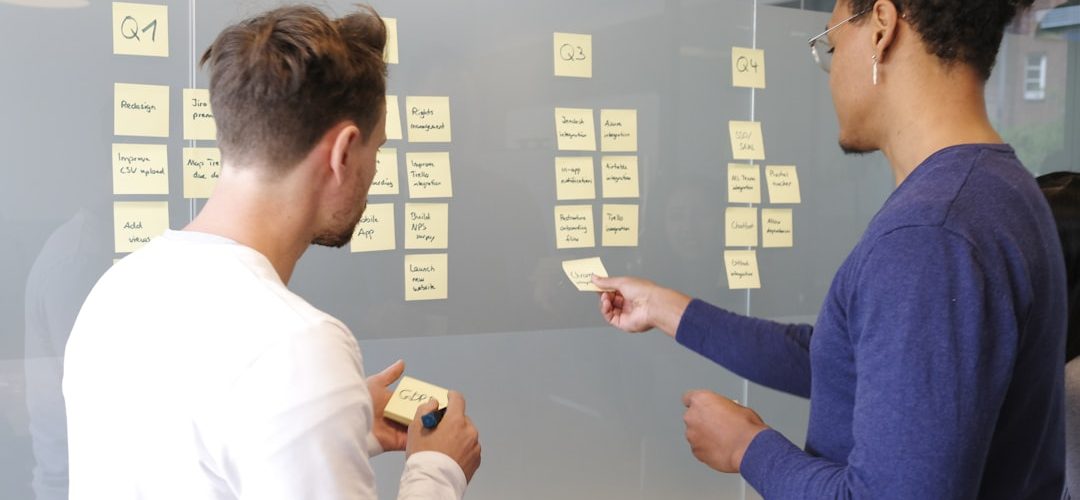 man in blue long sleeve shirt holding smartphone product roadmap planning team collaboration customer feedback