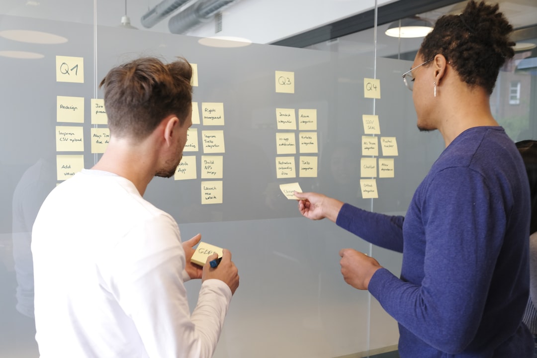man in blue long sleeve shirt holding smartphone product roadmap planning team collaboration customer feedback