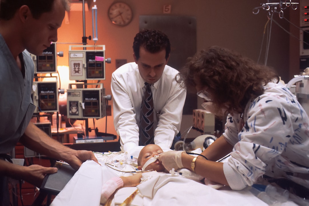 man in white dress shirt sitting beside woman in white long sleeve shirt medical simulation lab students training video review