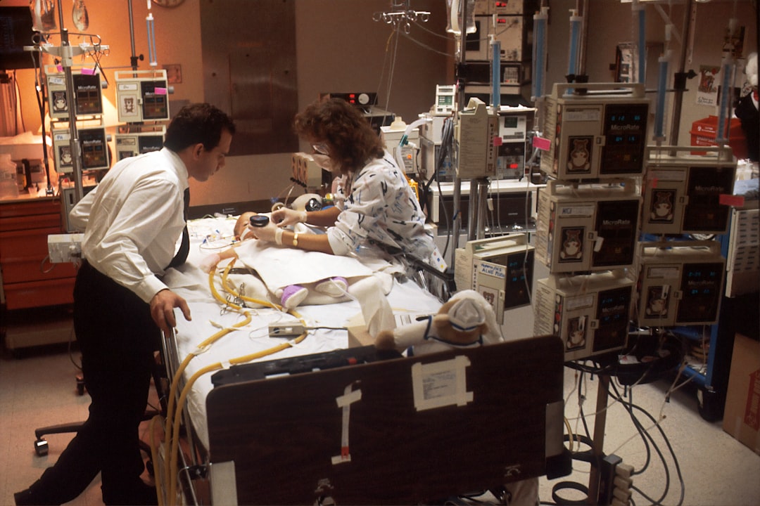 man in white dress shirt sitting on chair medical simulation lab students training video review