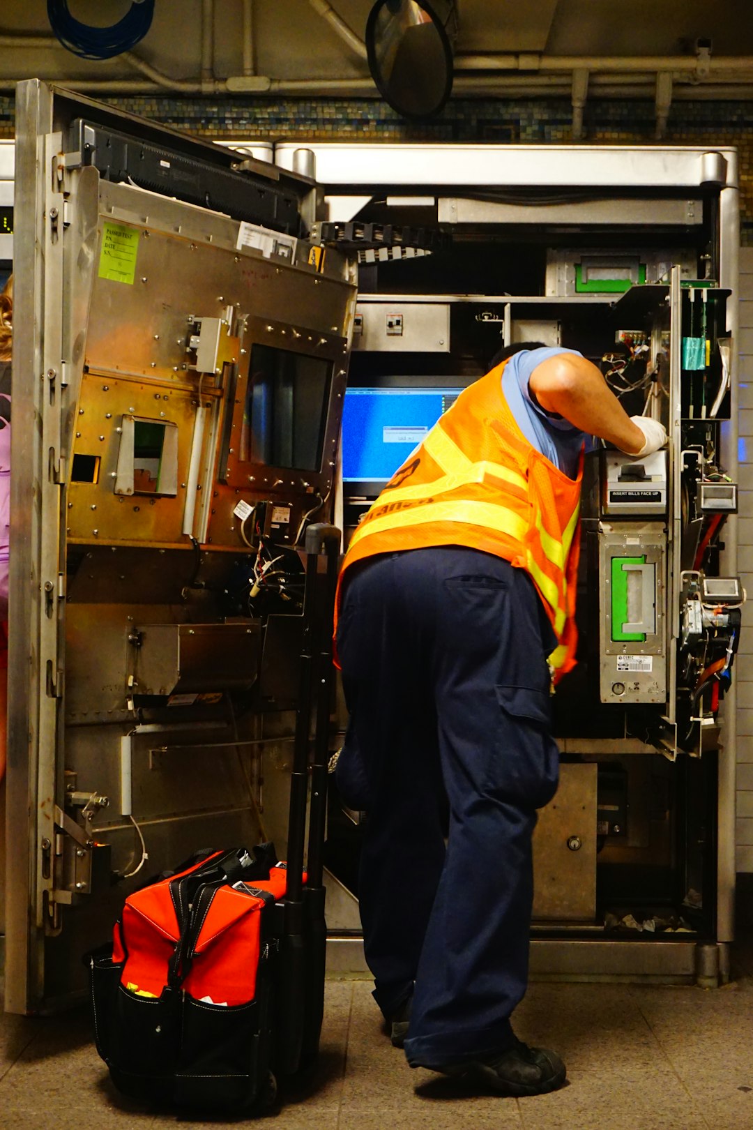 man standing and fixing machine facilities dashboard work orders asset maintenance operations team