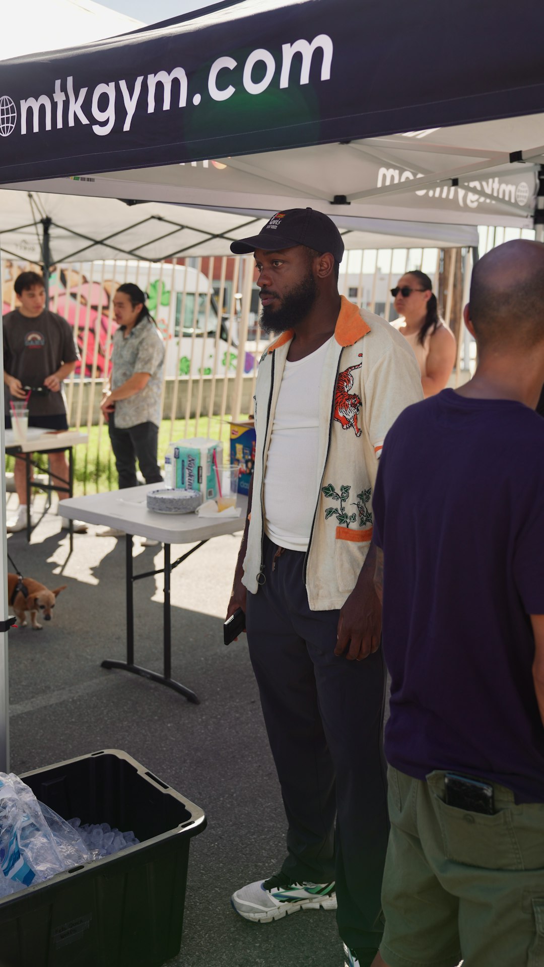 man standing under a tent with a website name local networking community event business links