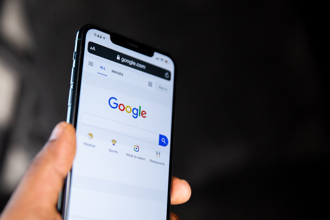 person holding black android smartphone local business website mobile search contact page