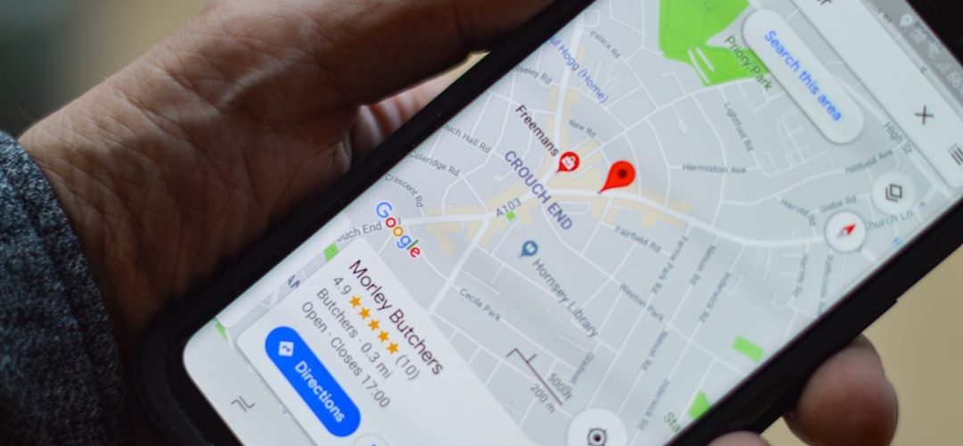 person holding black smartphone local map listing business profile search results
