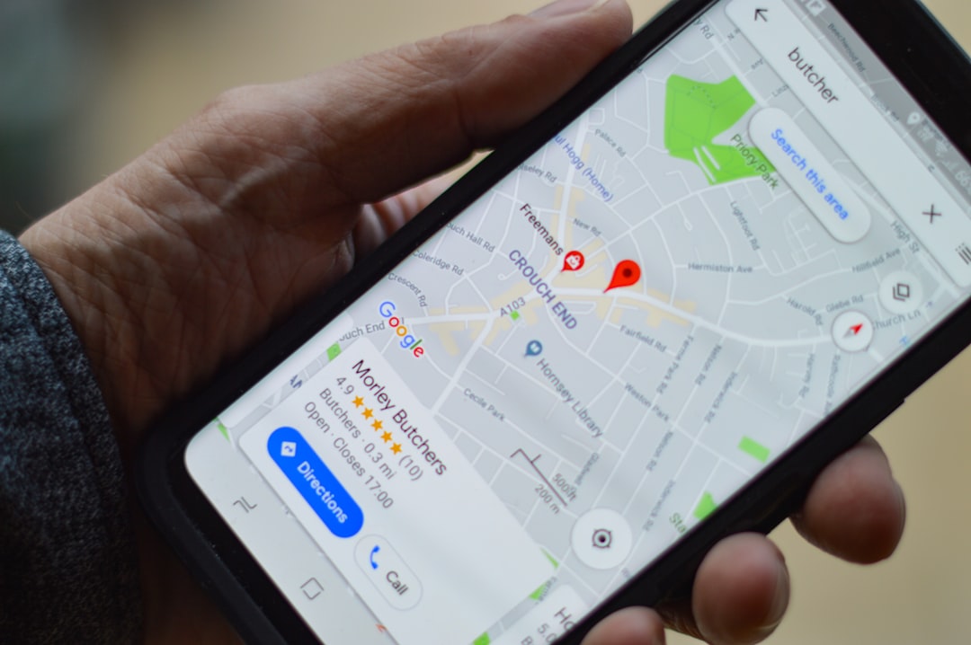 person holding black smartphone local map listing business profile search results