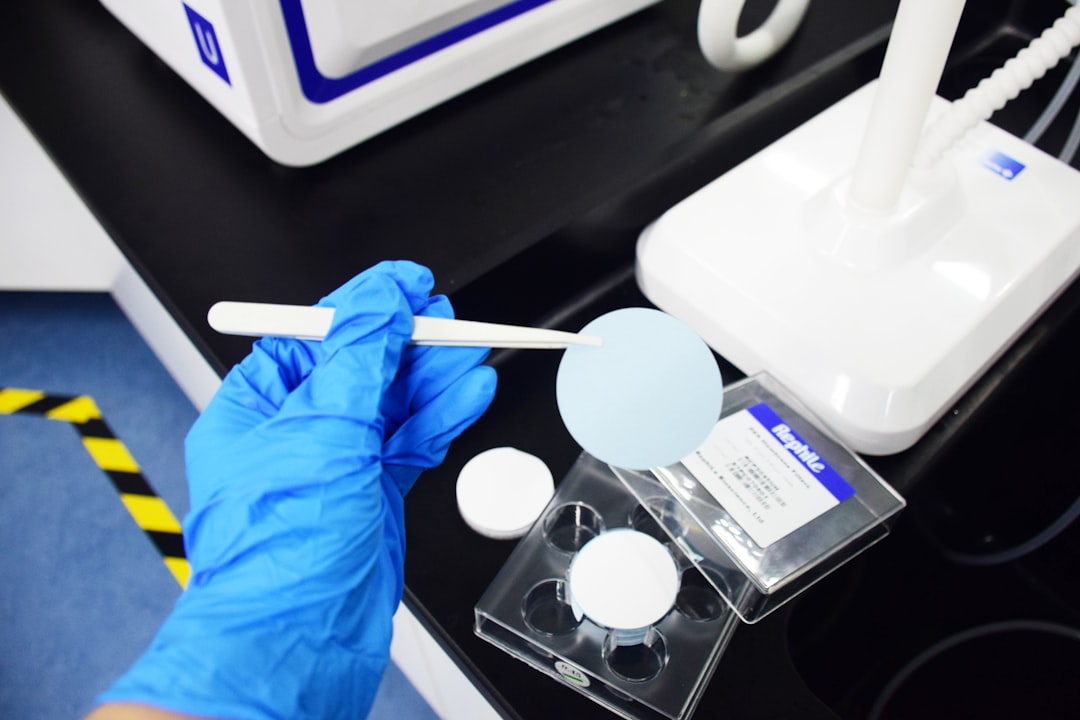 person holding white plastic spoon biotech team assay workflow clinical samples