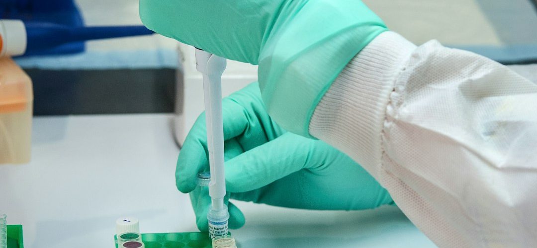 person in white long sleeve shirt holding green and white labeled can single cell analysis immune cells laboratory research