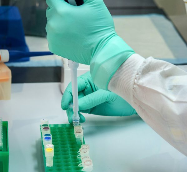person in white long sleeve shirt holding green and white labeled can single cell analysis immune cells laboratory research