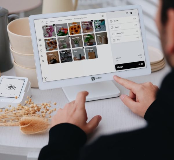 Best Building Maintenance Software for Facilities, Asset Management, and Preventive Maintenance 8 person using a tablet at a stores checkout multichannel sales marketplace orders inventory sync