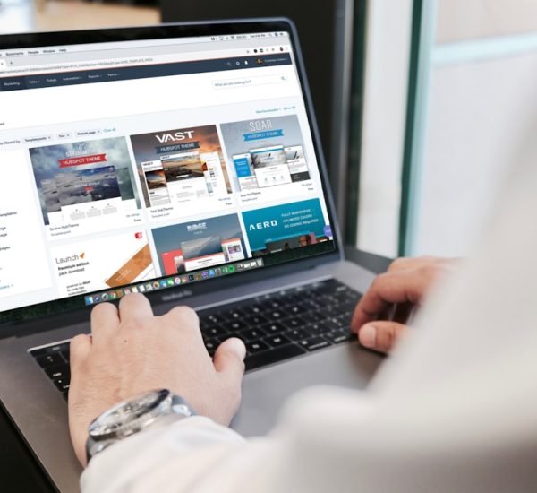 person using macbook pro ecommerce website laptop shopping cart
