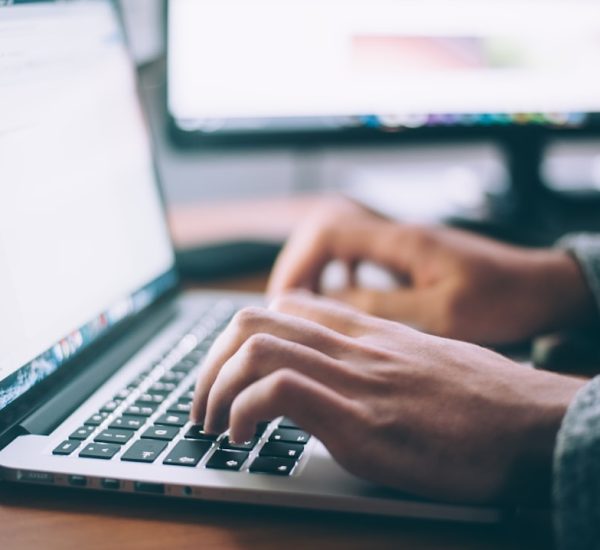 Formal Goodbye Email: Gmail vs Outlook for Writing Professional Farewell Emails 8 person using macbook pro professional email price inquiry office laptop