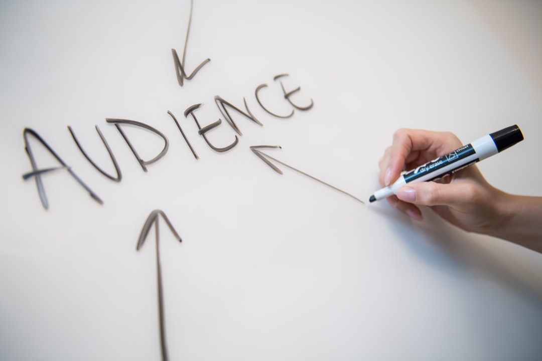 person writing on white paper audience targeting customer intent digital advertising
