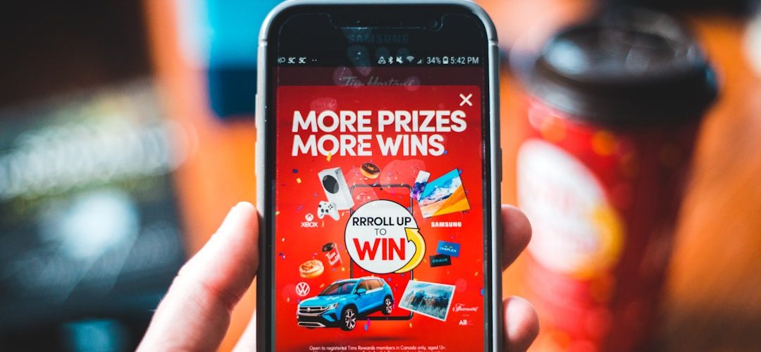 red and black smartphone showing game application customer quiz discount offer email signup