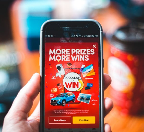 Fulfilled Order Emails: How Ecommerce Brands Can Improve Post-Purchase Communication 3 red and black smartphone showing game application customer quiz discount offer email signup