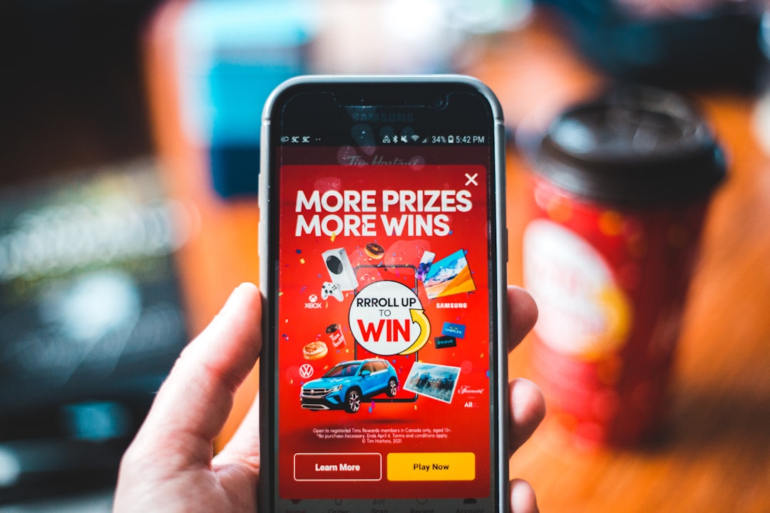 red and black smartphone showing game application customer quiz discount offer email signup